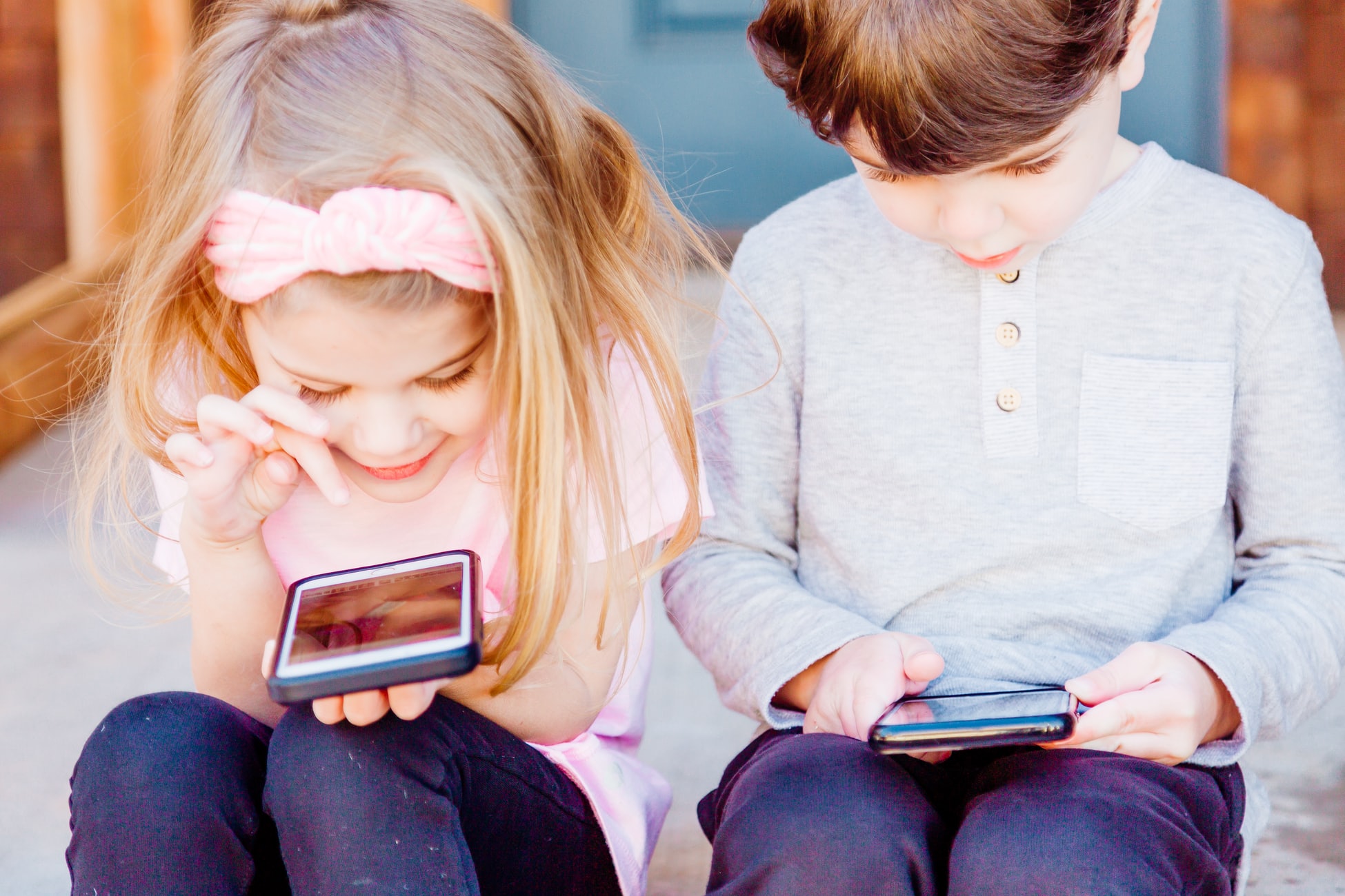 Young children looking at smartphone